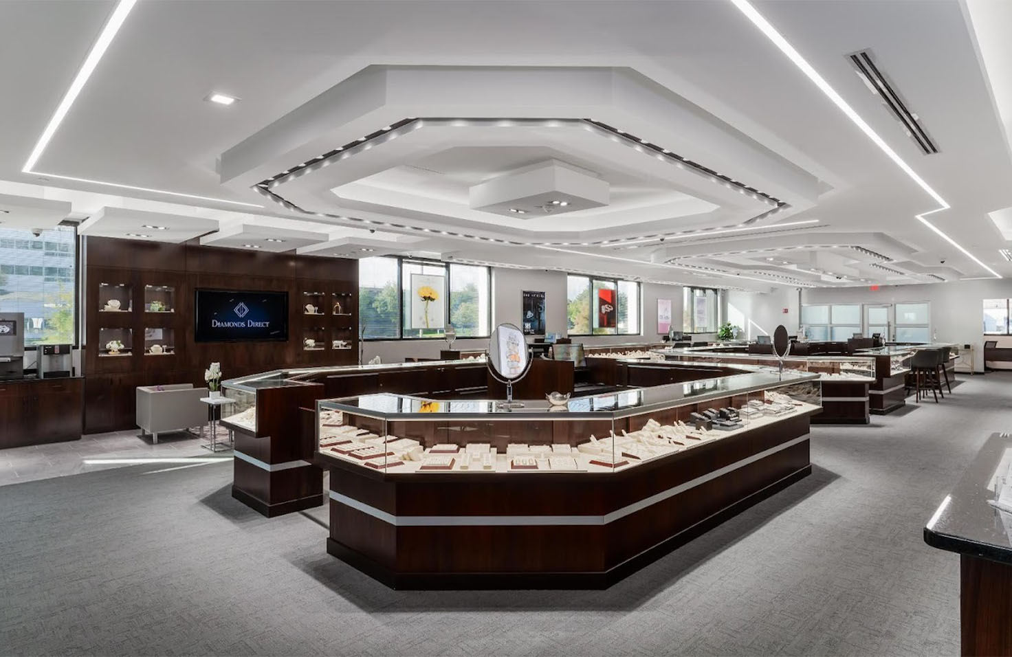 Diamonds Direct showroom interior with glass display cases showcasing diamond rings and fine jewelry collections.