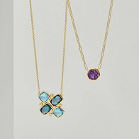 Layered yellow gold gemstone necklaces with blue topaz cluster pendant and purple gemstone pendant